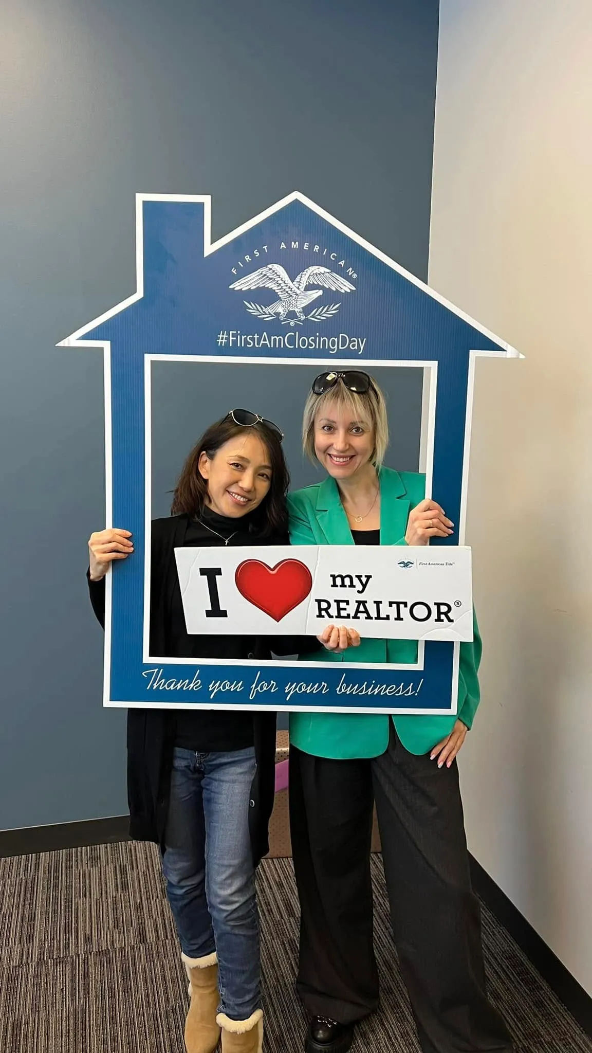 Client holding an "I love my REALTOR" sign with Tamila Aspen