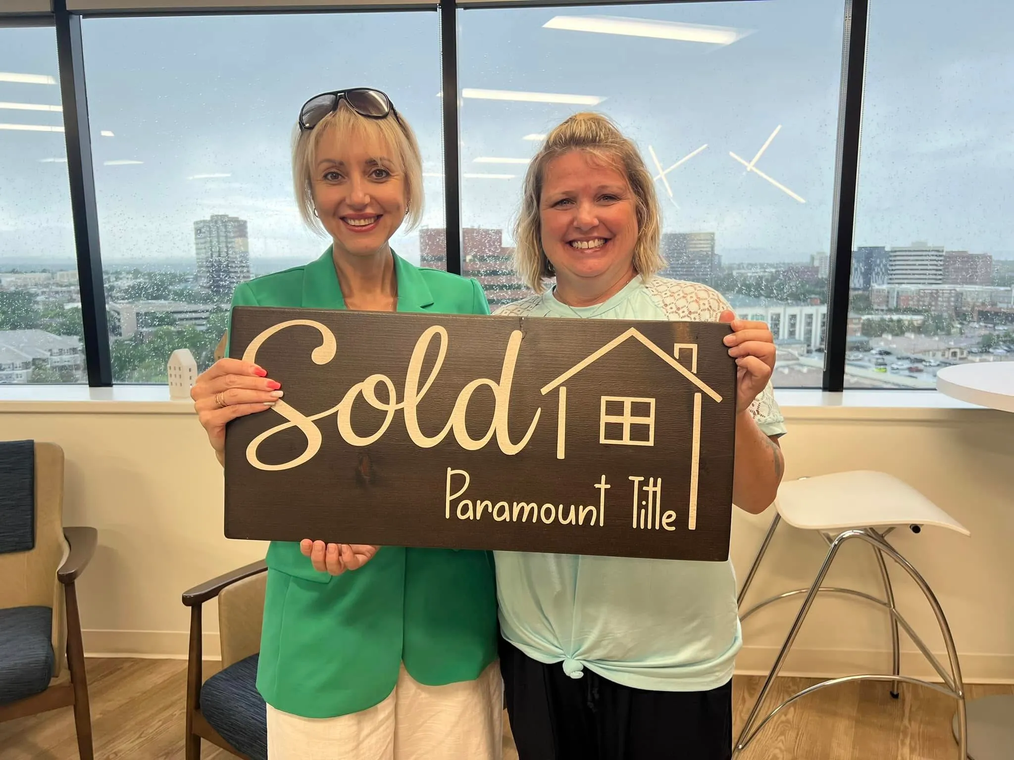 Tamila Aspen and a client holding a Sold sign at Paramount Title