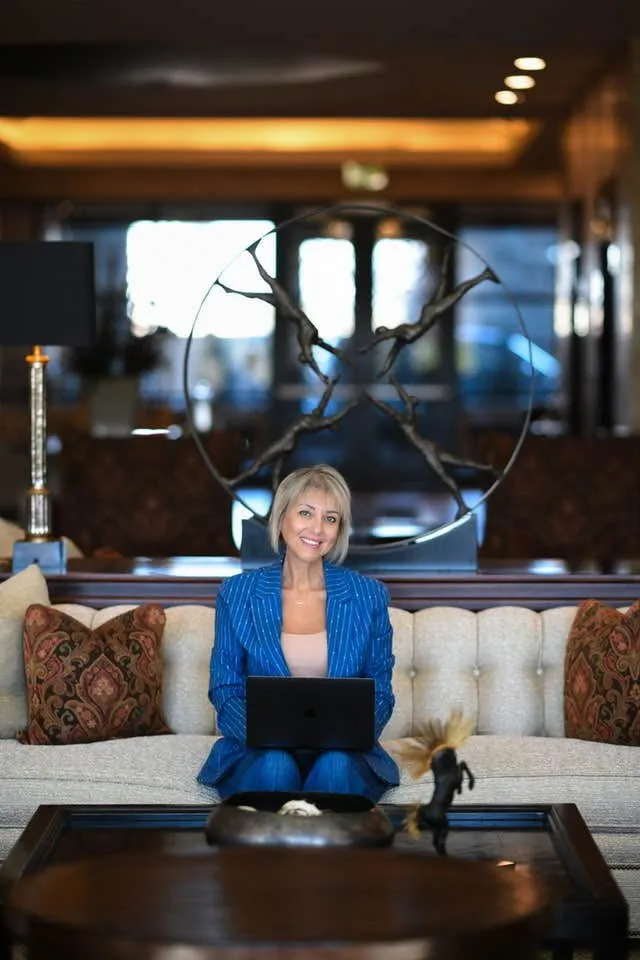 Tamila Aspen working on a laptop in a hotel lounge